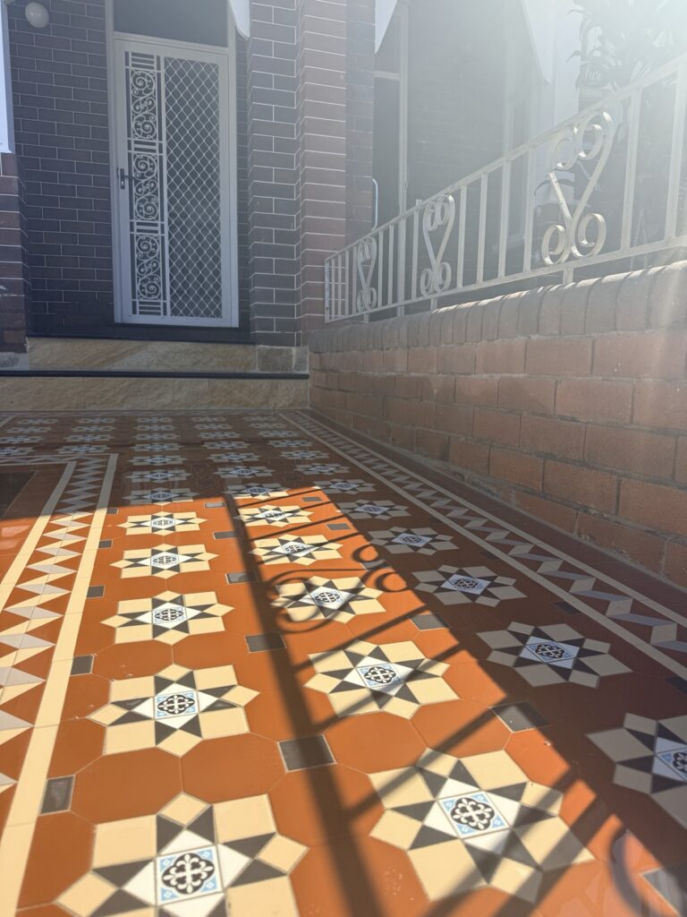 Sunlight across NightBridge tessellated tiles with EN-29 centres and a Balmain border in Coogee